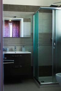 a bathroom with a sink and a glass shower at Armonia Galeta in Nardò