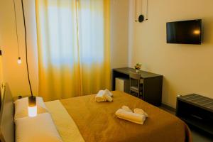 a hotel room with two towels on a bed at Armonia Galeta in Nardò