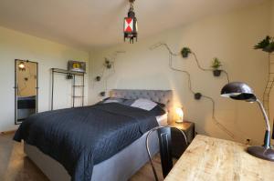 a bedroom with a bed and a table with a lamp at Ferienwohnung LOFT STUDIO ANNABERG in Annaberg-Buchholz