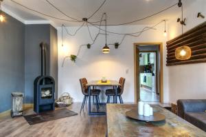 a living room with a table and a wood stove at Ferienwohnung LOFT STUDIO ANNABERG in Annaberg-Buchholz