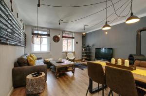 a living room with a couch and a table at Ferienwohnung LOFT STUDIO ANNABERG in Annaberg-Buchholz