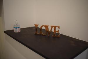 a wooden sign that says love sitting on a counter at Vento del sud in Modica