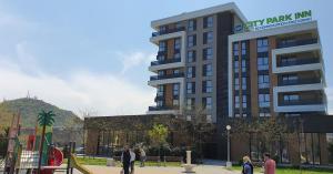 a group of people standing in front of a building at City Park Inn in Plovdiv