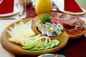 a plate of food with cheese and meats on a table at Mathias Rex in Szentendre