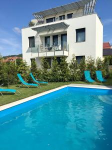 a house with a swimming pool in front of a building at Vaszary Secret Nest in Balatonfüred