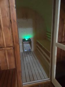 Cette petite chambre est dotée d'une lumière verte. dans l'établissement Rózsapark Vendégház, à Demjén