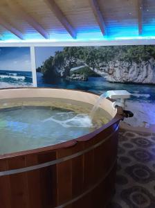 a jacuzzi tub with a view of the ocean at Rózsapark Vendégház in Demjén