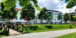 a wooden bridge in front of a white building at Apartment Holata 401 in Hradec Králové