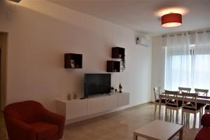 A television and/or entertainment centre at Melograno Home