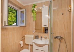 a bathroom with a sink and a toilet and a mirror at Sobe na Konalu in Dubrovnik