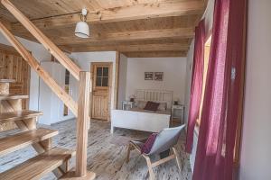 a room with a bed and a chair in it at Siedlisko Zakucie in Jaśliska