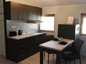 a kitchen with a small table and a sink at D&D Studio Apartment in Subotica