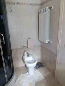 Baño pequeño con aseo y lavamanos en Casa vacanza Il Giardino, en Supersano