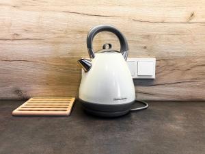 a tea kettle sitting on a counter next to a lightswitch at Beautiful studio for couples - Old Town & Main station in Krakow