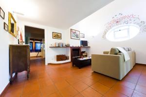 a living room with a couch and a fireplace at Villa Tara Gaeta in Gaeta