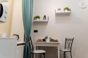 a small kitchen with a table and two chairs at Romantika Smolny appartment in Saint Petersburg