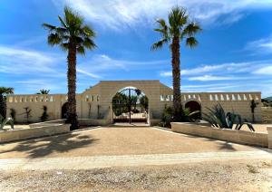 a building with two palm trees in front of it at Tropical Palm Villa in Monopoli