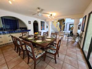 a dining room with a table and chairs at Casa del Arte, a luxury beachfront villa with private pool in Tela