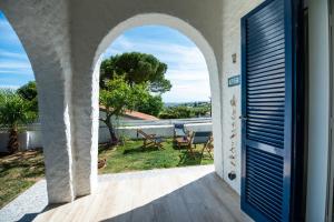 a door to a balcony with a view of a yard at Mirabelle in Numana