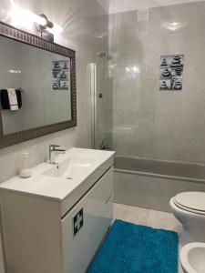a bathroom with a sink and a toilet and a shower at Refugio Praia da Rocha in Portimão +42 photos