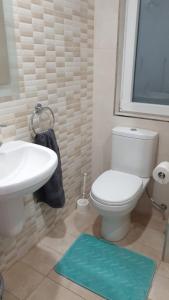a bathroom with a white toilet and a sink at Flat 2 Blue Waves in St Paul's Bay