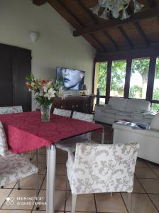 a living room with a table with a vase of flowers on it at La Rosa Selvatica in Ravarino