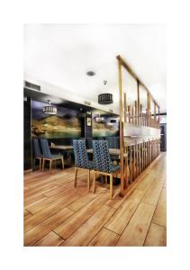 comedor con sillas azules y mesa en Hospedium Morada da Moa, en O Pindo