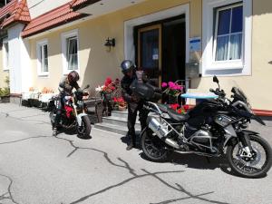 two motorcycles parked in front of a house at Hotel Kirchenwirt in Bad Kleinkirchheim