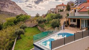 an image of a house with a swimming pool at NORMABEL relaxing villa with heated pool and sauna in Žrnovnica