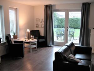 a living room with a couch and a table at Park Nest in Zeewolde