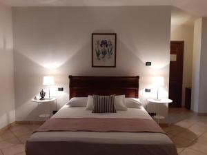 a bedroom with a large bed with two tables at Stella d'Italia in Sparone +8 photos