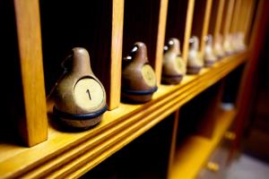 a row of bowling pins on a wooden shelf at Mathias Rex in Szentendre