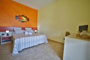 Postel nebo postele na pokoji v ubytování B&B La Casa di Attilio