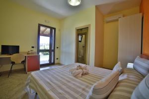 Postel nebo postele na pokoji v ubytování B&B La Casa di Attilio