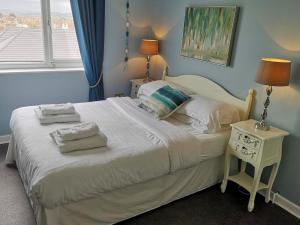 a bedroom with a bed with two pillows on it at The Sunfold in Weston-super-Mare