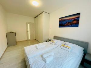 a bedroom with a bed with two towels on it at Apartmán Kežmarok in Kežmarok