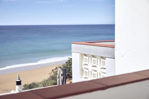 a view of the beach from the roof of a building at Casas Sul in Burgau