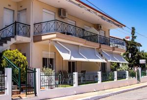 a building with umbrellas on the side of it at Starry Coast Apartments in Nea Potidaea