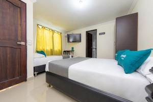 Cama o camas de una habitación en Hotel Verony San Joaquin
