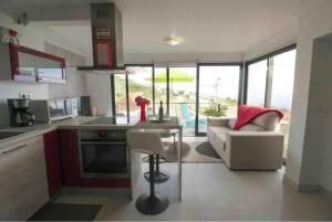 a kitchen and living room with a couch and a table at Crystal House in Calheta +32 photos