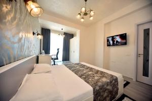 una habitación de hotel con una cama y un cuadro en la pared en Turquoise by the sea en Constanza