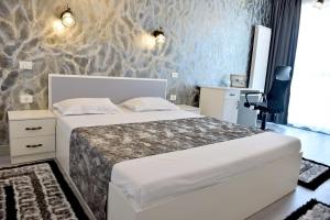 a bedroom with a bed in a room with a wall at Turquoise by the sea in Constanţa