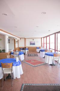 a room with tables and chairs with blue and white tables at Hali Hotel in Istanbul