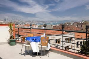 a table and chairs on a balcony with a view at Hali Hotel in Istanbul