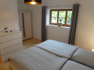 Schlafzimmer mit einem Bett und einem Fenster in der Unterkunft Ferienwohnung Nordlicht in Neuenkirchen