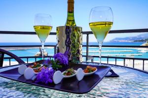 a table with a tray of food and wine glasses at Sole Mare in Ventimiglia