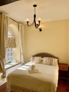 a bedroom with a bed with a towel on it at Willow House in Hereford