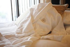 a white blanket on top of a bed at Hotel Granvia Kyoto in Kyoto