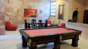 a living room with a pool table in a room at Pousada Canavieiras Frederic in Canavieiras