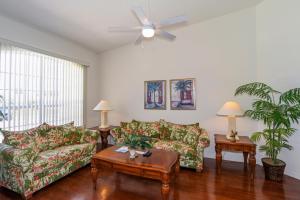 a living room with two couches and a ceiling fan at Foxrun Terrace Luxury 5BR Pool Villa in Inverness +15 photos